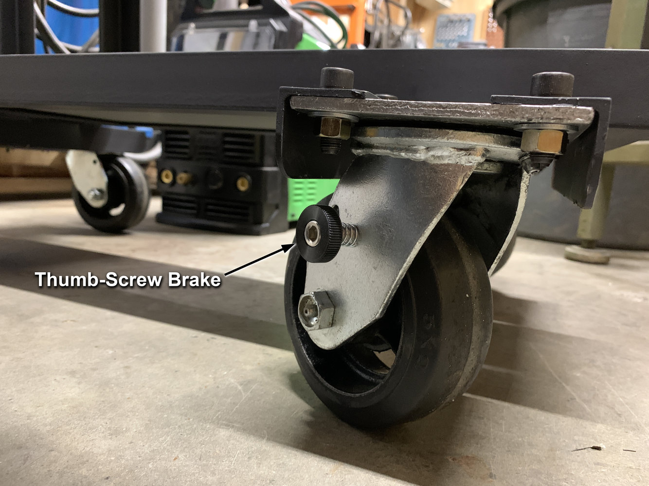 Thumb-screw brake installed on front casters.