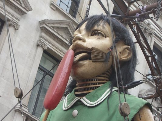 Giant_puppet_girl_licks_lolly.jpg